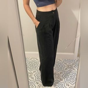 Black trousers, high waisted.